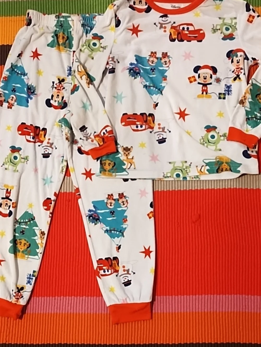 Disney Kids Holiday Pajama Set - White with Red Accents and Multicolor Prints.